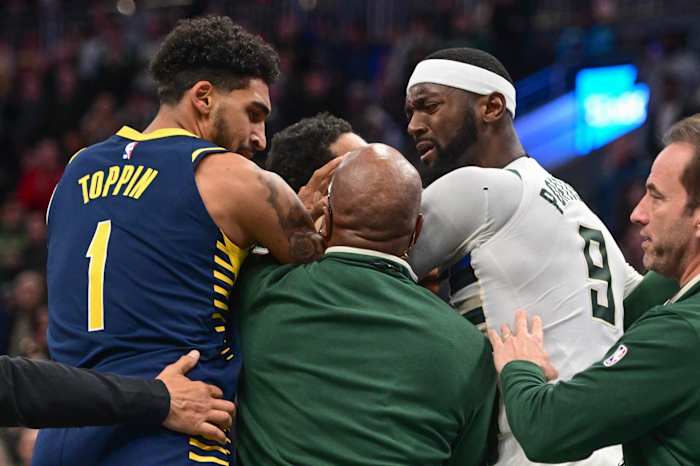 Coaches try to separate Milwaukee Bucks forward Bobby Portis (9) and Indiana Pacers forward Obi Toppin (1)